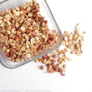 Roasted split peanuts (bhaja badam, bhuni moongphali) on a white background